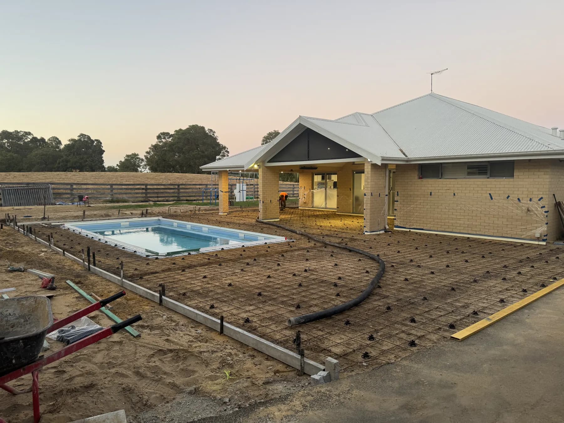 Pool surround formed with mesh and chairs ready for concrete